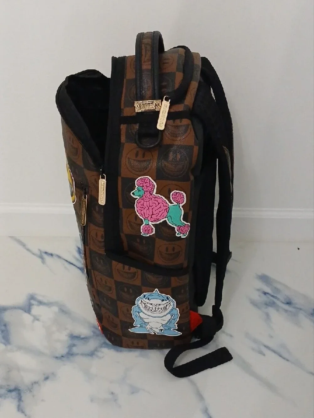Sprayground Brown Checkerboard Backpack with Multicolor Sticker Graphics